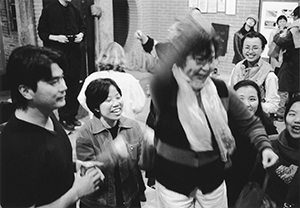 Just after the beginning of the new year - guests at a party in the Tang clan ancestral hall, Ping Shan, with party host fashion designer William Tang at the left, 1 January 1997