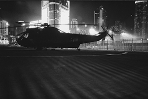 Royal Navy helicopter with Citic Tower (left) and site of the British Farewell ceremony (right) behind, 27 June 1997