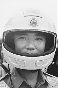 Motorcycle policeman with British colonial emblem on his helmet, near the City Hall, 29 June 1997