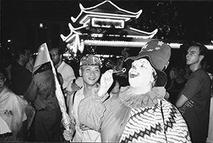 Clown blowing bubbles at a pro-democracy rally outside the Legislative Council Building on the night of the handover, 1 July 1997