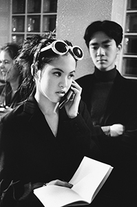 Young amateur fashion model pretending to use a mobile phone, as part of the Clothink event at the Visual Arts Centre, Hong Kong Park, 17 January 1998