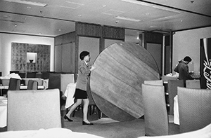 Rolling away a table top as a restaurant approaches closing time, Wanchai, 28 March 1997