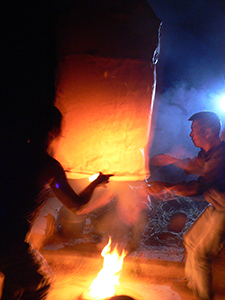 Launching a sky lantern during the Mid-Autumn Festival, Sheung Wo Hang Village, North East New Territories, Hong Kong, 6 October 2006