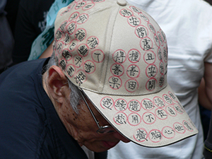 Protester in the annual pro-democracy march with message on his hat, 1 July 2007