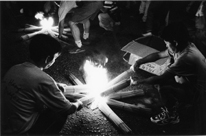 Lighting incense sticks at the Tai Hang Fire Dragon parade, Tai Hang, 22 September 2001