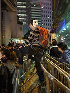 Demonstrator with a mask, outside the Legislative Council Building, Chater Road, protesting against the construction of a high speed rail link to Mainland China, 16 January 2010