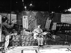 Nelson Hiu performing at the ‘Occupy’ protest camp in the public plaza beneath the Hong Kong and Shanghai Bank headquarters, Central, 12 December 2011