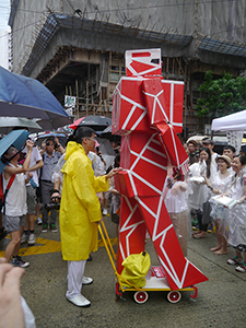 Kacey Wong with his robot sculpture, on the annual pro-democracy march, 1 July 2013