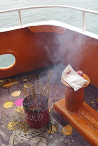 Incense sticks burning on a boat to Joss House Bay on the birthday of Tin Hau, 22 April 2014