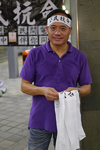 Handing out headbands before a rally at the Tamar site to launch the Occupy Central movement, 31 August 2014