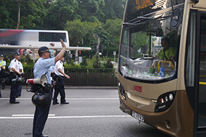 Police stopping a bus because the road has just been blocked by demonstrators sitting down, Queensway, 28 September 2014