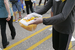 Handing out yellow ribbons at the Mongkok Umbrella Movement occupation site, 30 September 2014