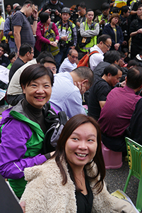 Audrey Eu (left), participating in a sit-in on the final day of the Admiralty Umbrella Movement occupation site, 11 December 2014