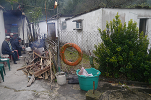 Trying to keep warm by an outdoor fire on a very cold day, Sai Wan Tsuen, Sai Kung, 24 January 2016