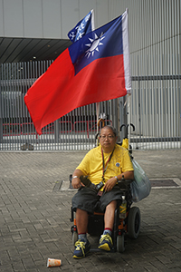 Demonstrator in wheelchair with Taiwanese flag, Admiralty, 1 July 2016