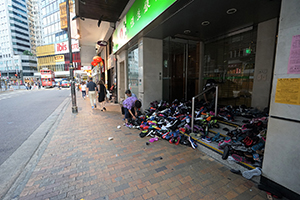 Temporary shoe shop in the doorway of a bank on a day it is closed, Des Voeux Road West, Sheung Wan, 1 May 2018