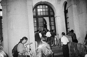 Democratic Party leader Martin Lee entering the legislative Council Building along with other democrats shortly after the transfer of sovereignty has occurred at midnight, 1 July 1997