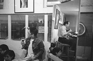 Poetry reading by Leung Ping-kwan at Visage One, Central, with a reflection in a hairdressing mirror, 4 May 1996