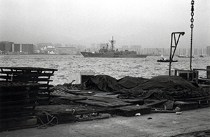The Wanchai waterfront at dusk, with an American warship in the harbour, 24 May 1996