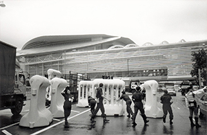 Police moving crowd control barriers near the Hong Kong Convention and Exhibition Centre, Wanchai, 1 July 1997