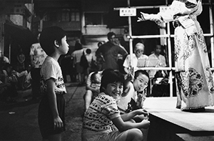 Young audience members at an outdoor Chinese opera performance, Tung Street, Sheung Wan, 17 August 1997