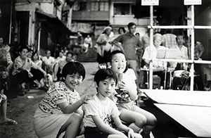 Young audience members at an outdoor Chinese opera performance, Tung Street, Sheung Wan, 17 August 1997