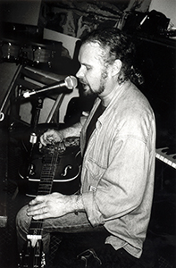 Musician Roy Stark singing and playing guitar, Visage Too, Tai Ping Shan, 7 March 1998