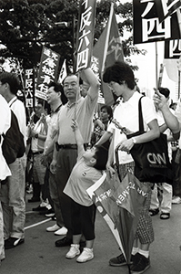 Politician Frederick Fung amongst marchers leaving Victoria Park after a rally - on a march to the Central Government Offices, 31 May 1998