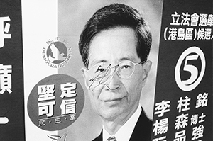 Kerbside election banner with defaced image of Martin Lee, leader of the Democratic Party, Queen Elizabeth Stadium, Wanchai, 9 May 1998