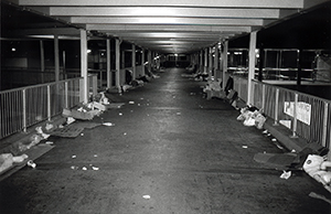 Walkway from Queensway Plaza just after midnight, with rubbish left behind by domestic helpers who have been camping out there on their day off, Admiralty, 15 June 1998