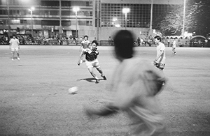 Game of football under floodlights in Southorn Playground, Wanchai, 17 October 1998
