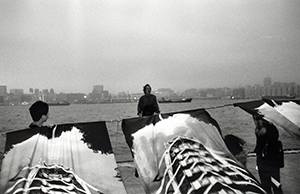 Performance by artist Ichi Ikeda on a pier behind Oil Street artist village, North Point, 27 February 1999