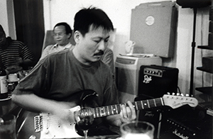 Yank Wong playing guitar, Club 64, Wing Wah Lane, Central, 26 June 1999
