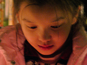 Young visitor concentrating on the act of making an origami crane, Sense 99, Wellington Street, 15 January 2005