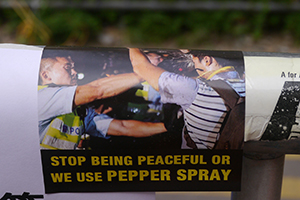 Sticker concerning the use of pepper spray, on the final day of the Admiralty Umbrella Movement occupation site, Tim Mei Avenue, 11 December 2014