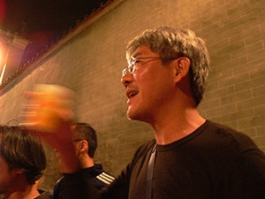 Photographer John Fung, at a celebration of the Lunar New Year in the Tang clan ancestral hall, Ping Shan, north-western New Territories, 11 February 2005