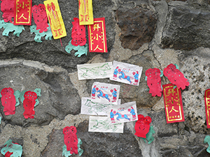 Stone wall on Hollywood Road with ritual paper items placed on it, Hong Kong Island, 5 March 2005