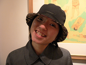 Connie Lam, with a painting by Wilson Shieh behind, Central, 10 May 2005