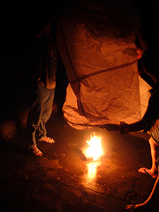 lnflating a paper hot air balloon prior to launch, as part of a traditional Mid-Autumn Festival celebration at Sheung Wo Hang Village, north-eastern New Territories, 18 September 2005