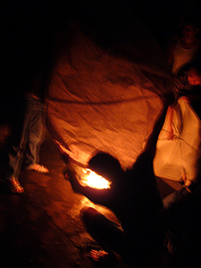 lnflating a paper hot air balloon prior to launch, as part of a traditional Mid-Autumn Festival celebration at Sheung Wo Hang Village, north-eastern New Territories, 18 September 2005