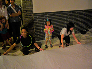 People preparing a paper hot air balloon, as part of a traditional Mid-Autumn Festival celebration at Sheung Wo Hang Village, north-eastern New Territories, 18 September 2005