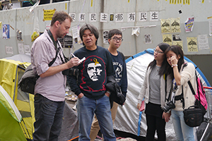 Leung Kwok-hung being interviewed, on the final day of the Admiralty Umbrella Movement occupation site, Harcourt Road, 11 December 2014