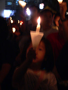 Young participant holding a candle in the June Fourth memorial rally, Victoria Park, 4 June 2005