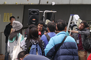 Student leader Alex Chow being interviewed on the final day of the Admiralty Umbrella Movement occupation site, Harcourt Road, 11 December 2014