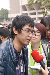 Student leader Alex Chow being interviewed on the final day of the Admiralty Umbrella Movement occupation site, Harcourt Road, 11 December 2014