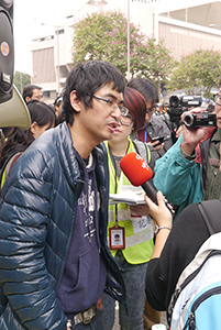 Student leader Alex Chow being interviewed on the final day of the Admiralty Umbrella Movement occupation site, Harcourt Road, 11 December 2014