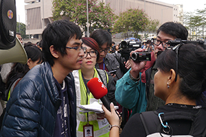 Student leader Alex Chow being interviewed on the final day of the Admiralty Umbrella Movement occupation site, Harcourt Road, 11 December 2014