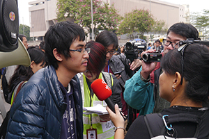Student leader Alex Chow being interviewed on the final day of the Admiralty Umbrella Movement occupation site, Harcourt Road, 11 December 2014