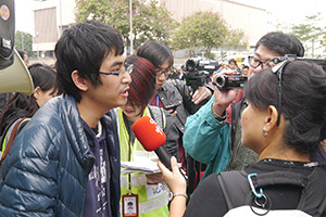 Student leader Alex Chow being interviewed on the final day of the Admiralty Umbrella Movement occupation site, Harcourt Road, 11 December 2014