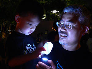 Political cartoonist Zunzi and his son, at the June Fourth memorial rally, Victoria Park, 4 June 2007